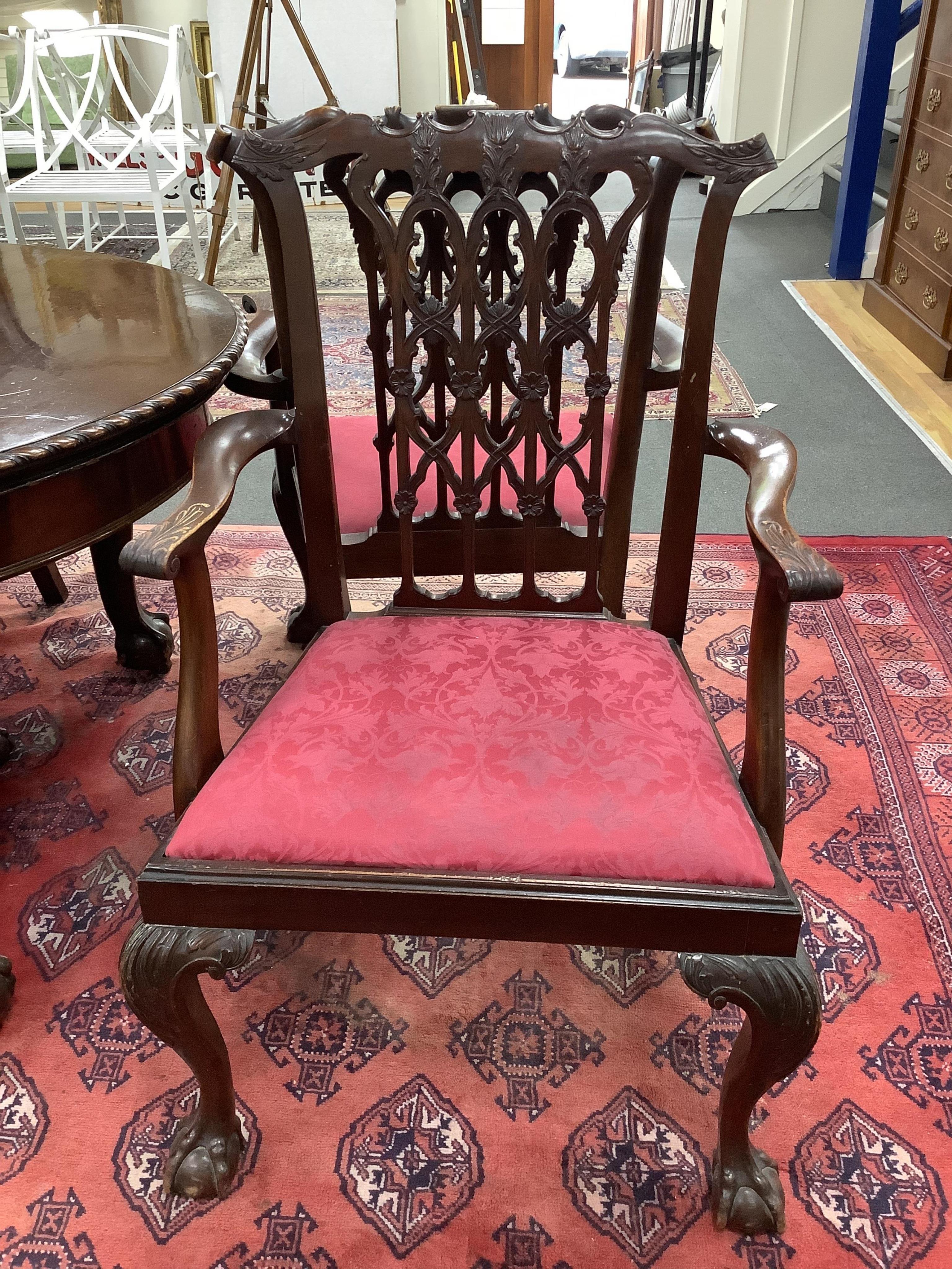 A Chippendale Revival mahogany dining suite comprising an extending dining table, width 300cm extended, depth 122cm, height 74cm, ten chairs (two with arms), a serpentine sideboard and a serving table. Condition - fair t